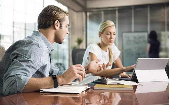 Conference meeting of two young professionals using Microsoft Surface and Office 365