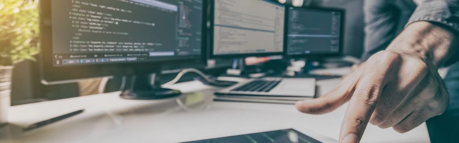 Hand typing on a tablet lying on a desktop