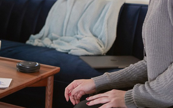 woman using a speakerphone at home