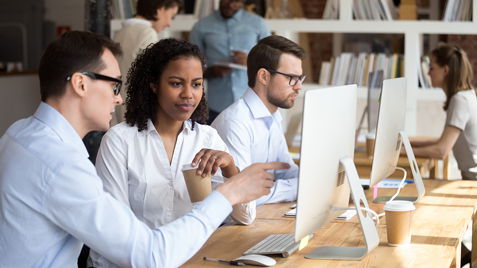 Colleagues working together in an open office